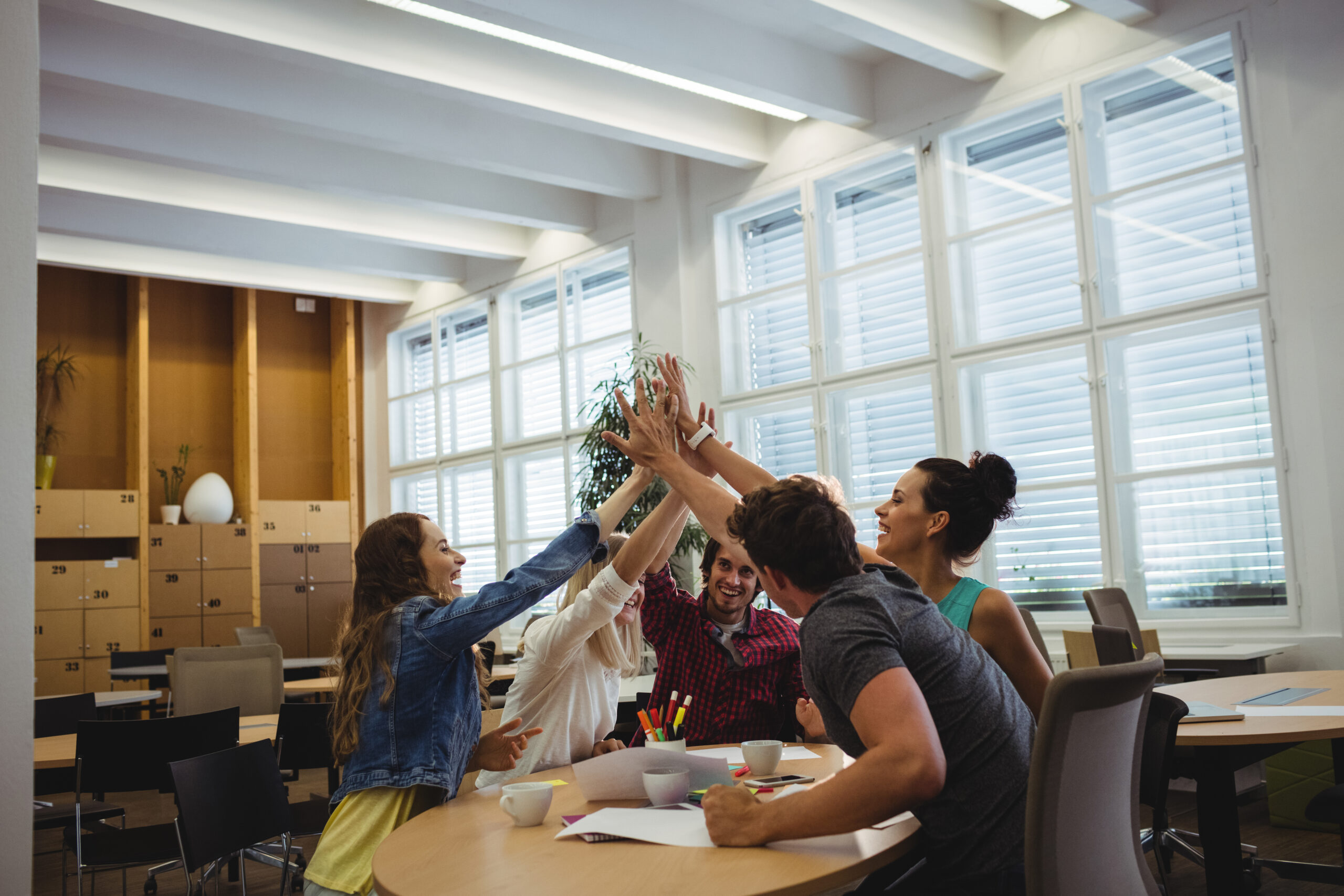 group of business executives giving high five